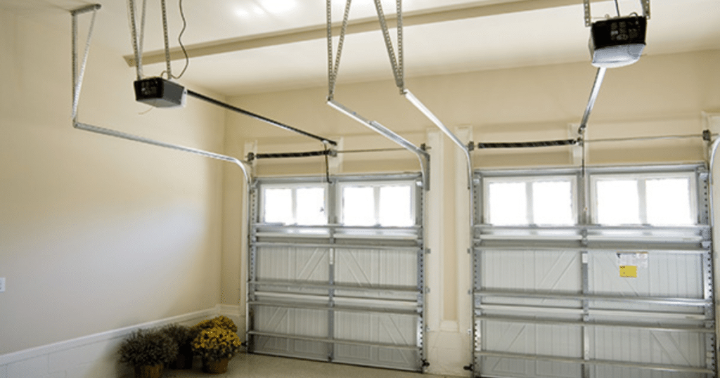 Dual garage doors with ceiling openers installed.